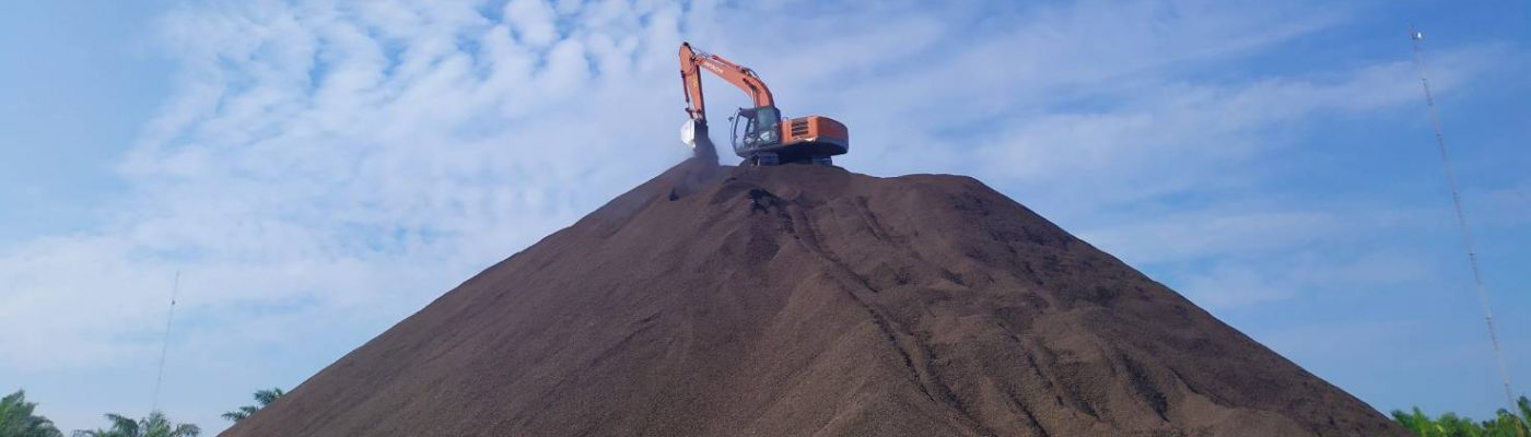 Excavator working on PKS stockpile